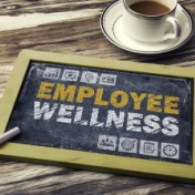 chalkboard on table that reads employee wellness