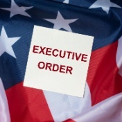 words executive order on card on top of American flag