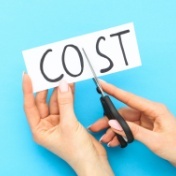 person with scissors cutting the word cost in half