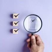 checkboxes with checkboxes and magnifying glass with hand